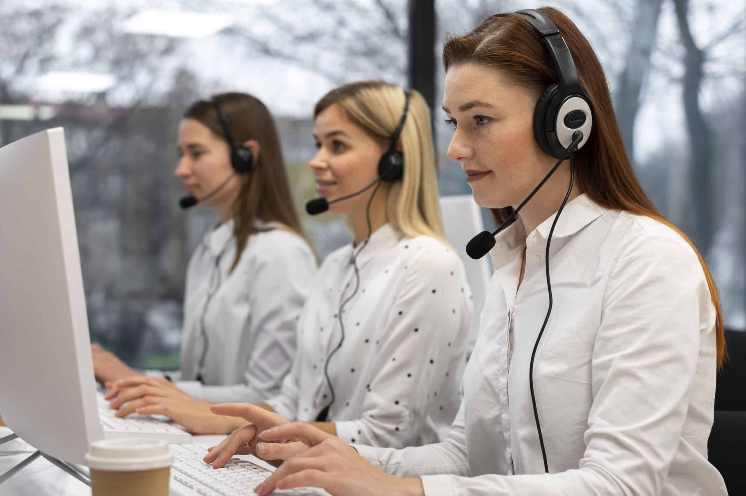 colleagues-working-together-call-center-with-headphones-min