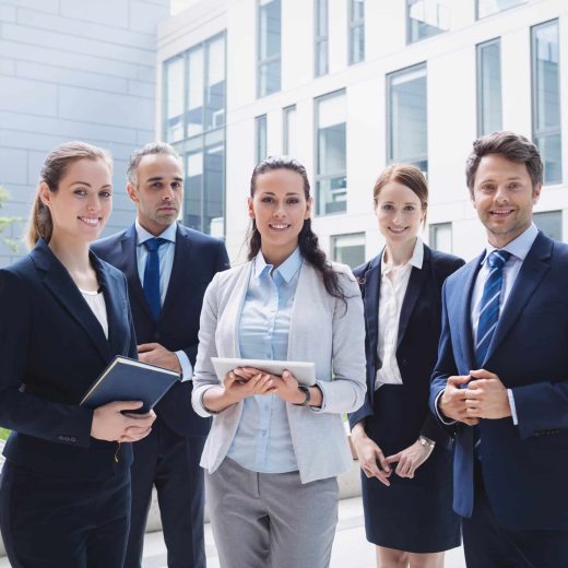 businesspeople-standing-outside-office-building-min